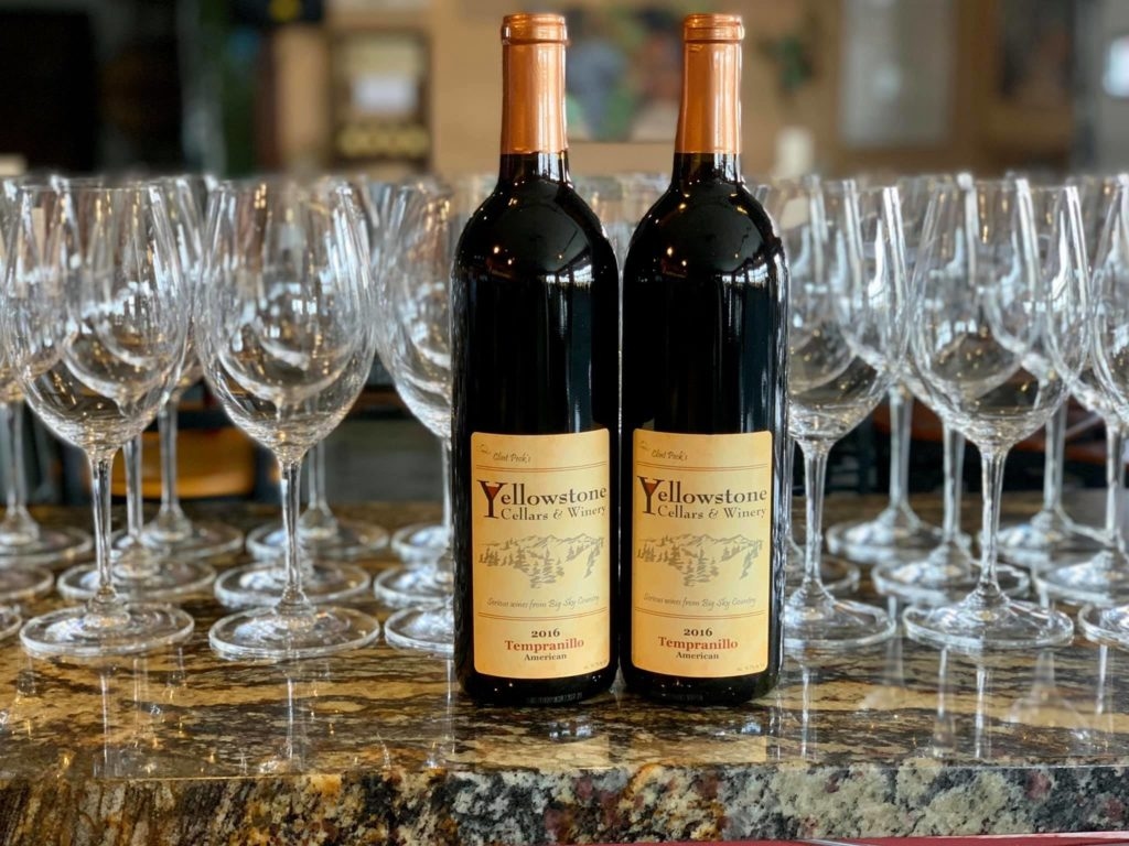 Several bottles of wine sit lined up on the counter in the tasting room of Yellowstone Cellars and Winery.