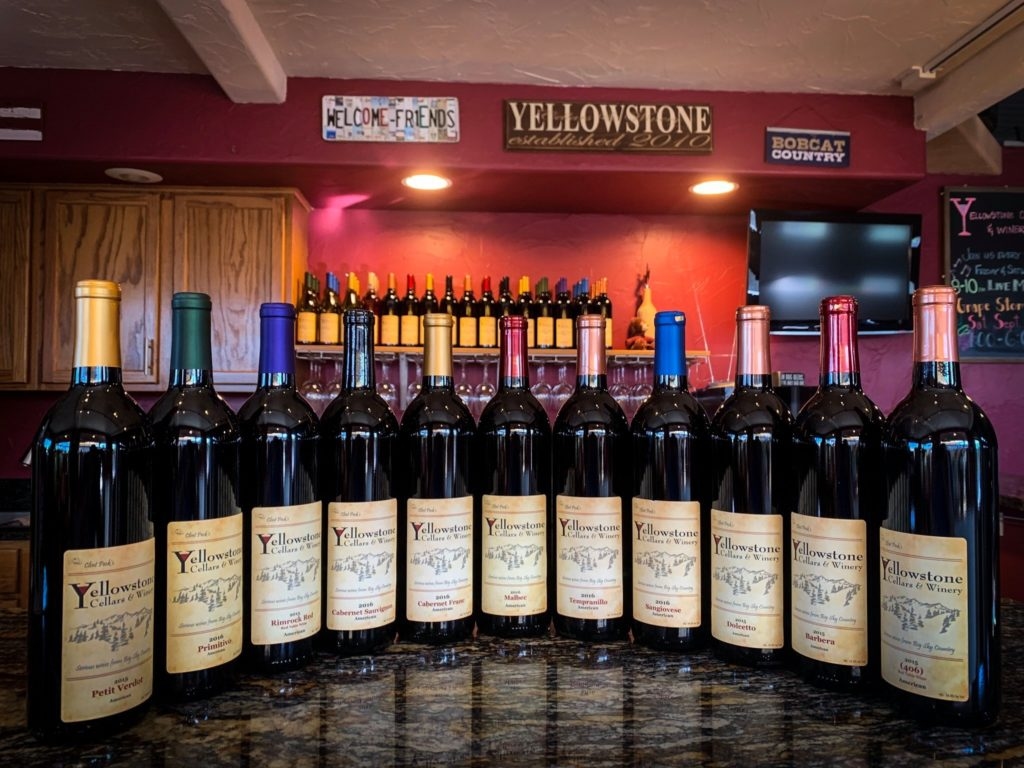 Several bottles of wine sit lined up on the counter in the tasting room of Yellowstone Cellars and Winery.
