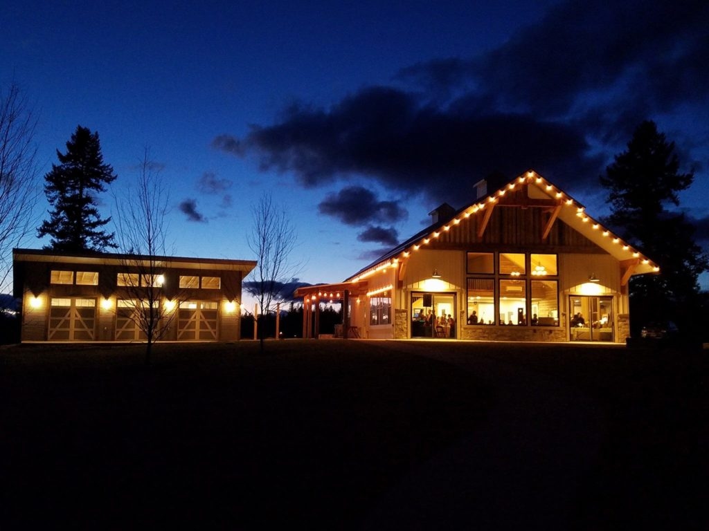 The SIlver Knot wedding venue sits lit up against a night sky.